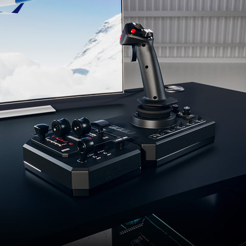 A high-end flight simulator joystick and control pad set on a dark desk in front of a screen showing a snowy mountain scene.